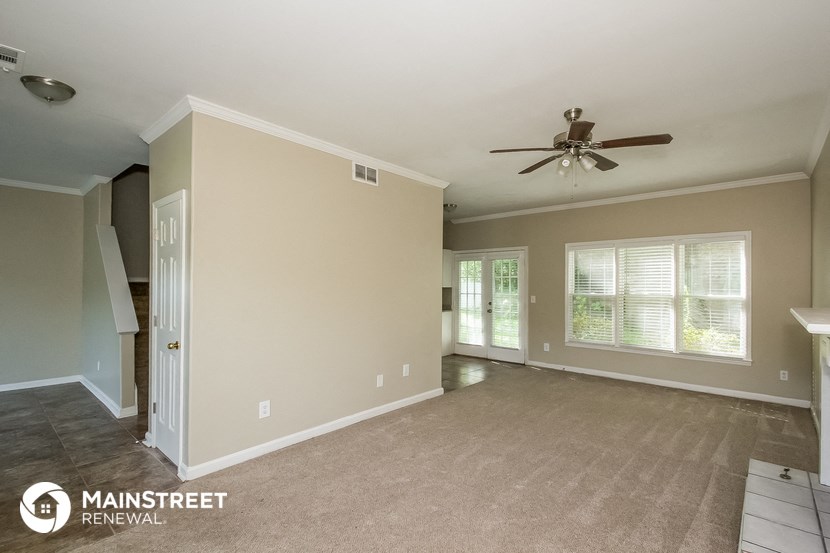 the living room and dining room with ceiling fan