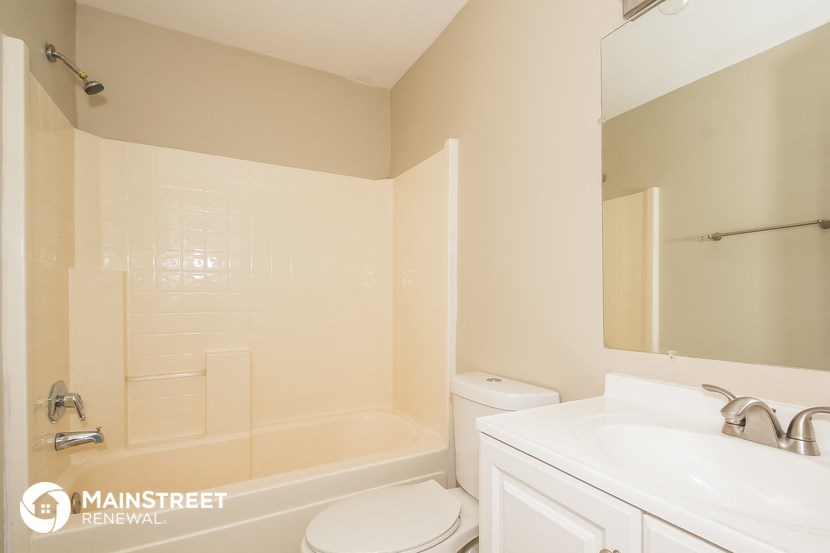 a bathroom with a sink toilet and a tub