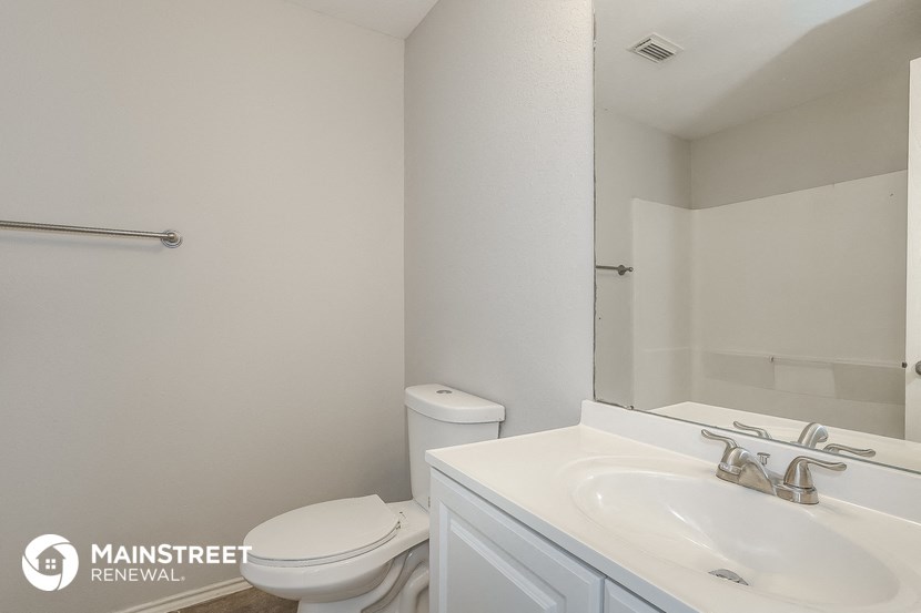 a bathroom with a sink and a toilet and a mirror