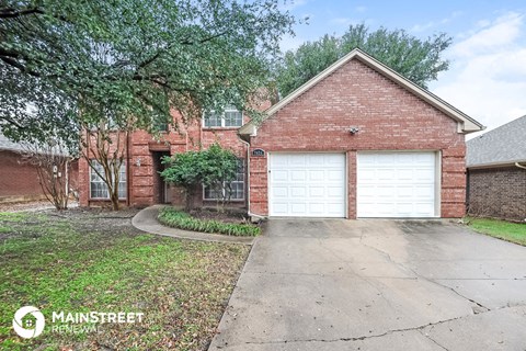 a brick house with a white garage door