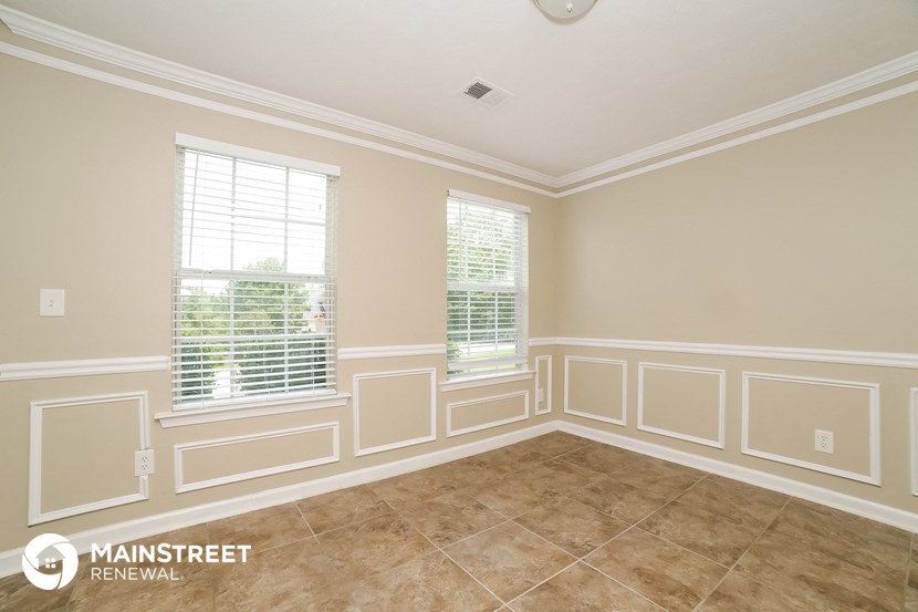 an empty room with white walls and a tiled floor