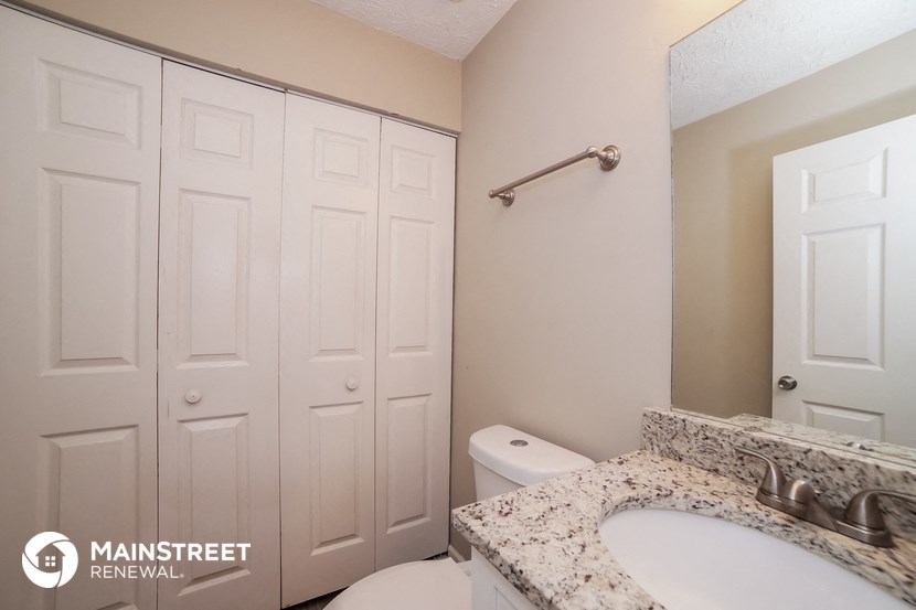 a bathroom with a sink and a toilet and a mirror