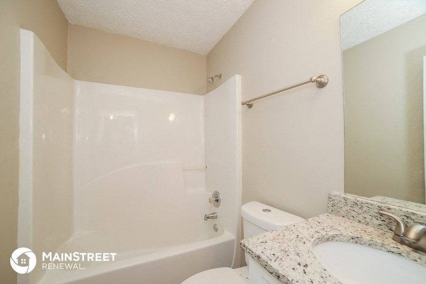 a bathroom with a sink and a shower and a toilet