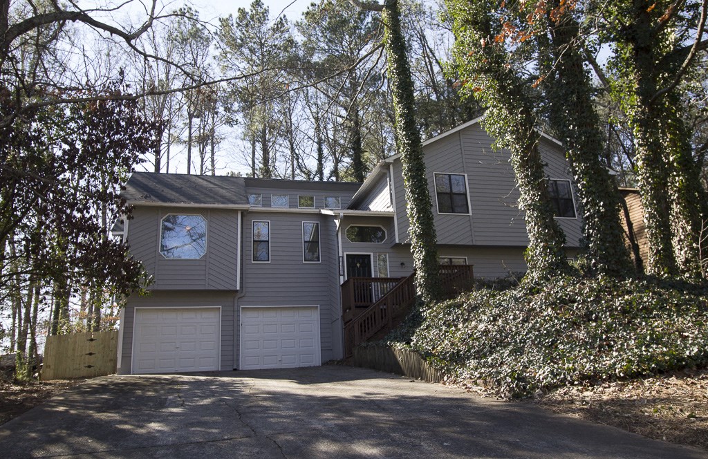 the front of a house with a garage and a driveway