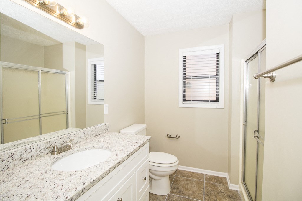 a bathroom with a sink toilet and a shower