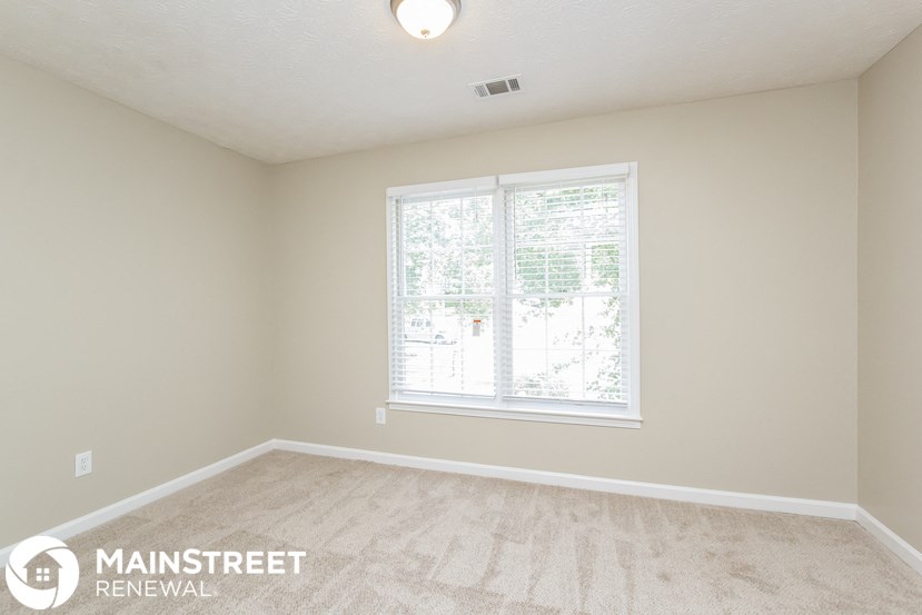 the living room of a new home with a large window