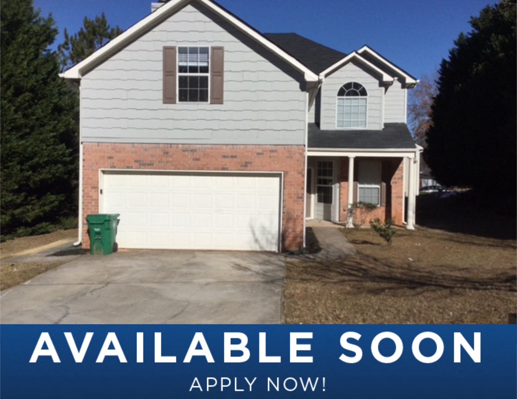 a white house with a white garage door and a driveway