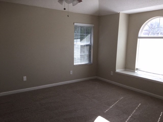 an empty living room with a large window