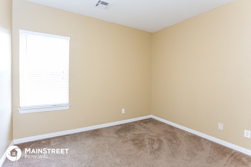 a room with a carpet and a window