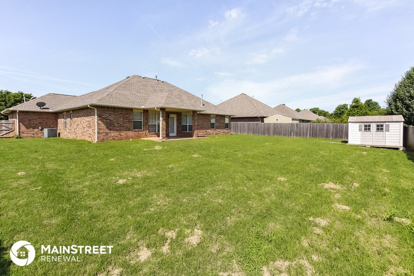 the backyard of a house with a yard and a fence