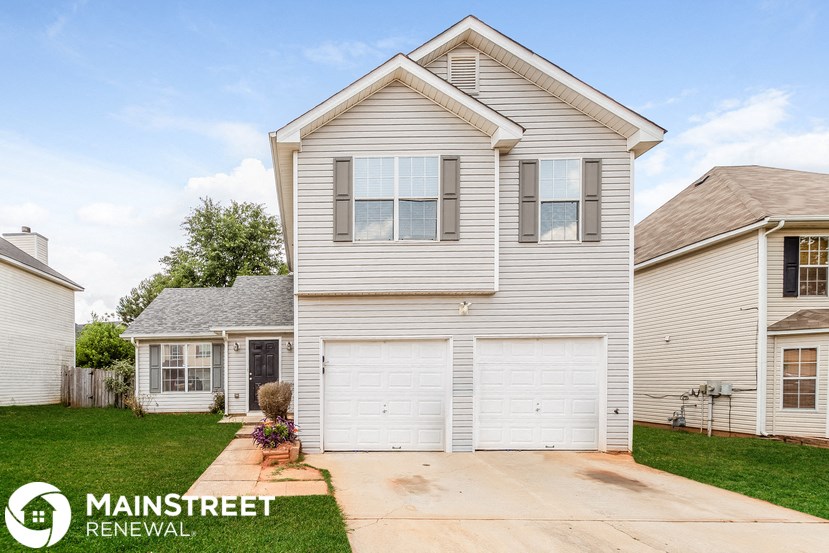 a white house with a white garage door