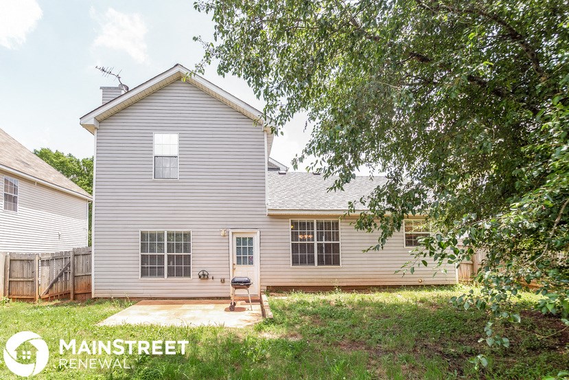 a white house with a backyard and a patio