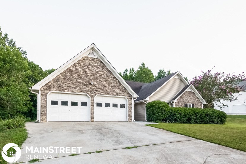 a home with two garage doors and a driveway