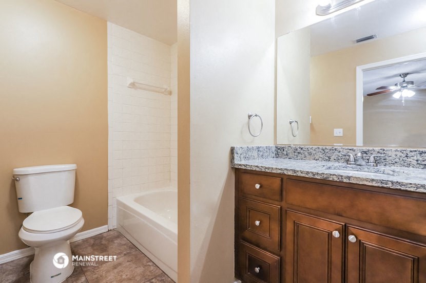 a bathroom with a toilet and a shower and a sink