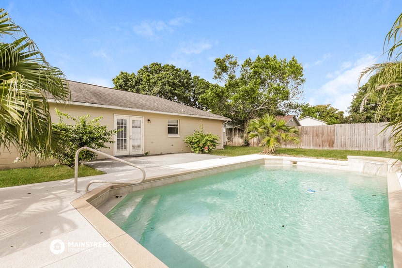 a pool with a house in the background