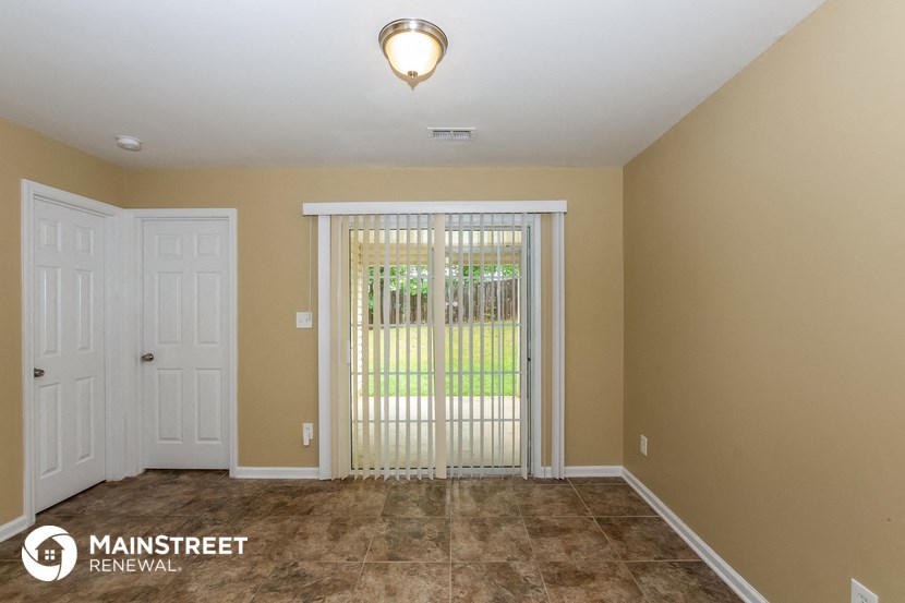 the living room of a house with a door to a yard