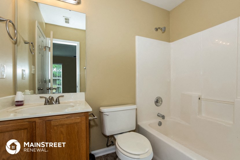 a bathroom with a sink toilet and a bath tub