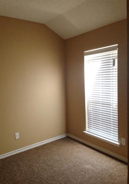 a room with a window and a carpet