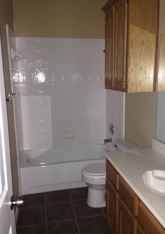 a bathroom with a toilet and a tub and a sink