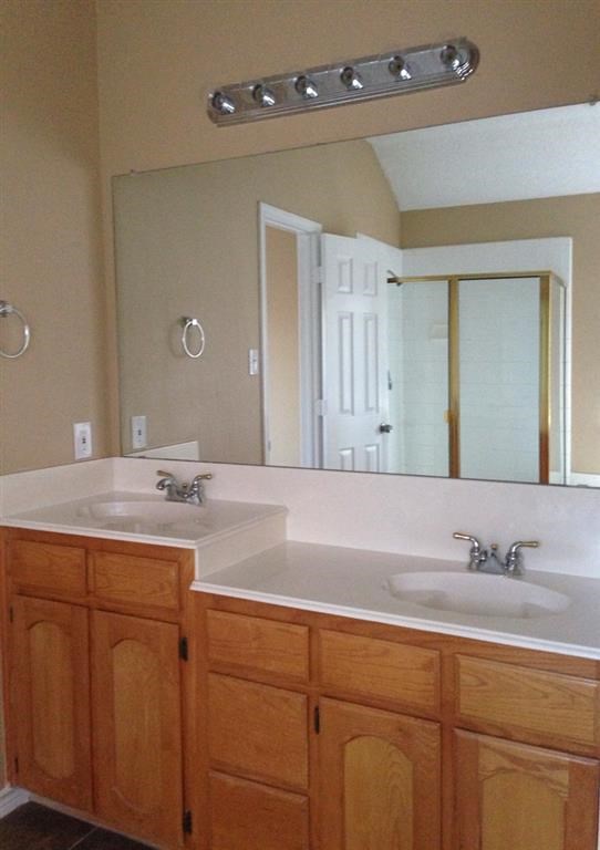 a bathroom with two sinks and a large mirror