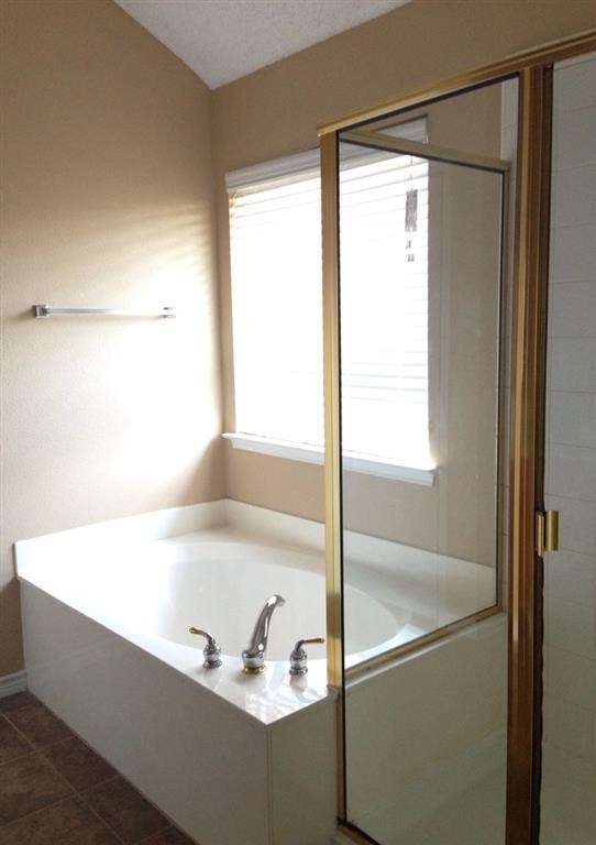 a bathroom with a sink and a shower and a window