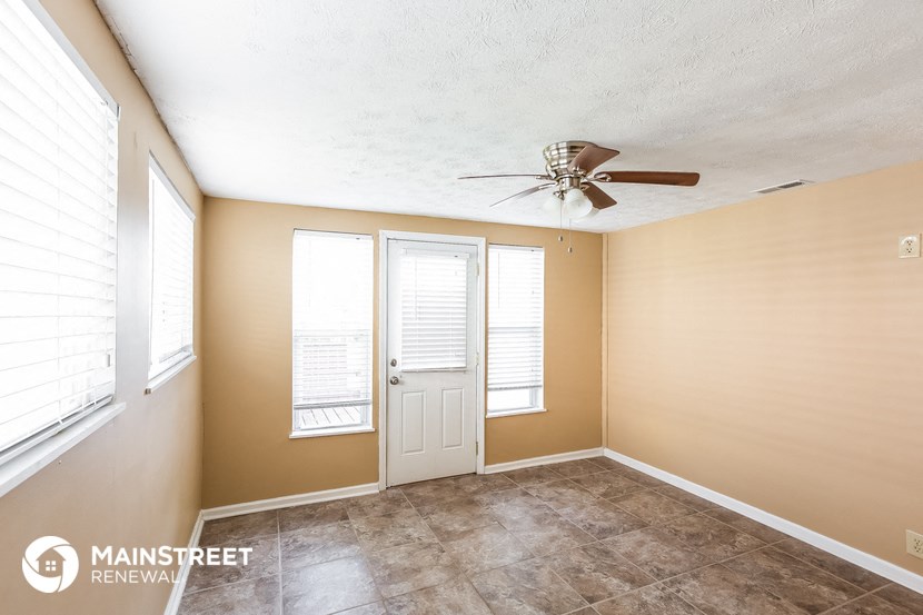 the living room of a home with a ceiling fan