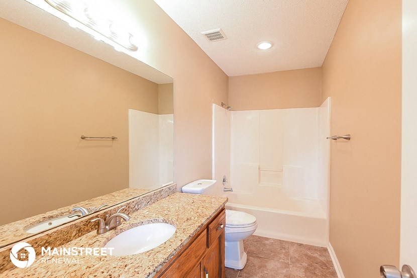 a bathroom with a sink and a toilet and a shower