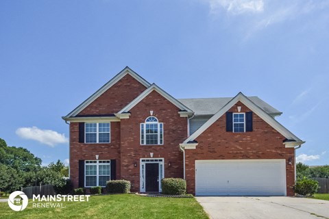 a large brick house with a blue sky in the background