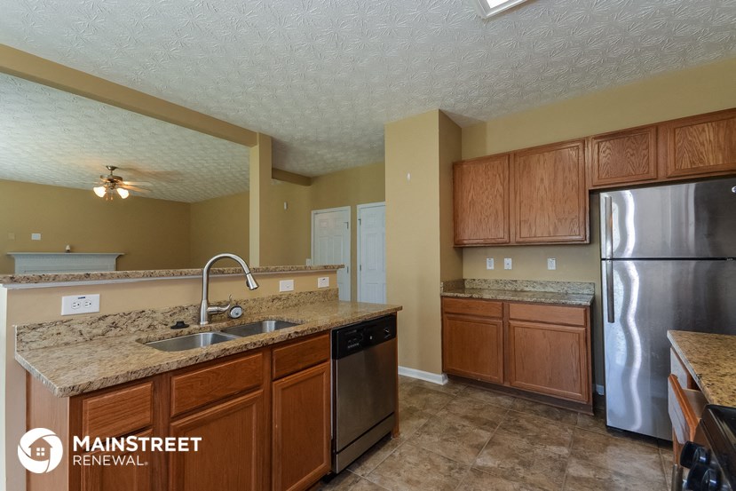 a kitchen with stainless steel appliances and granite counter tops