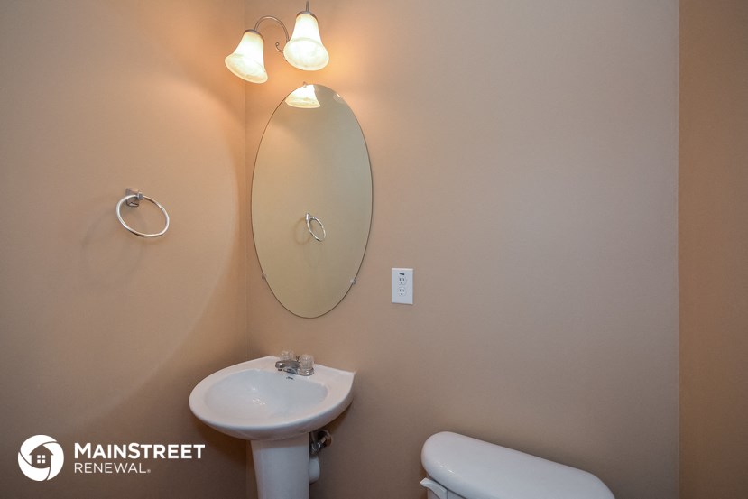 a small bathroom with a sink and a mirror