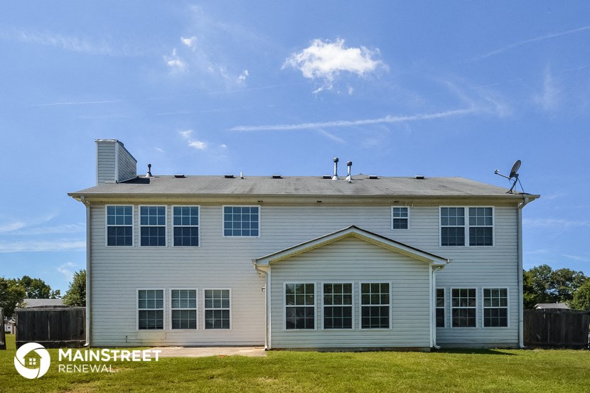 a white house with a satellite dish on the roof