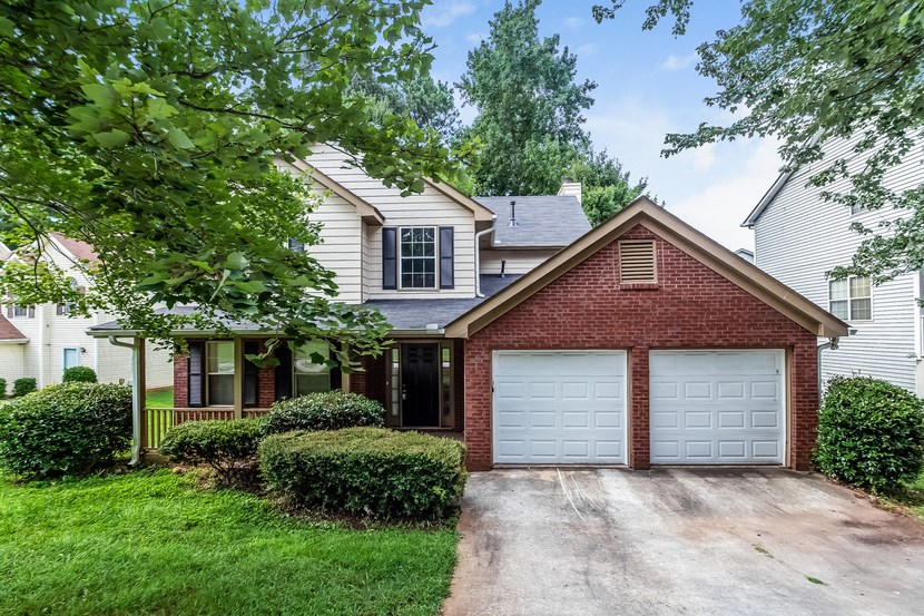 a house with a white garage door in front of it