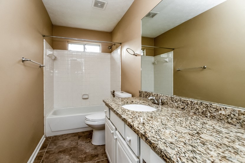 the preserve at ballantyne commons apartment bathroom with tub and sink and toilet