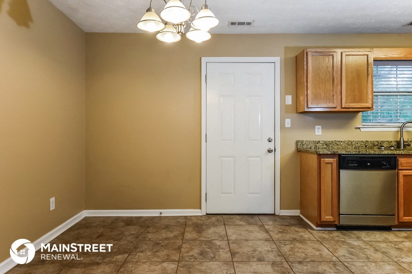 a kitchen with a sink and a white door