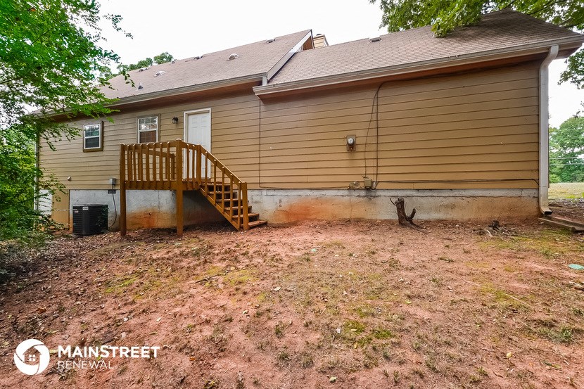 the back of a house with a yard and a deck