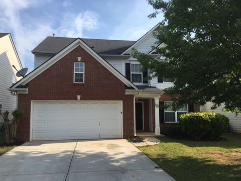 a red brick house with a white garage door