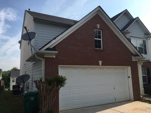 a brick house with a white garage door