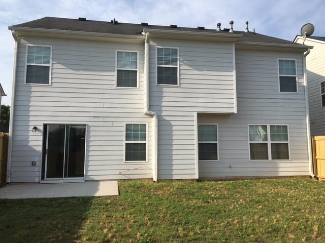 a white house with a yard in front of it