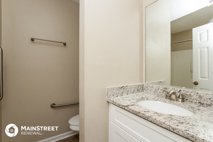 a bathroom with a sink and a mirror and a toilet