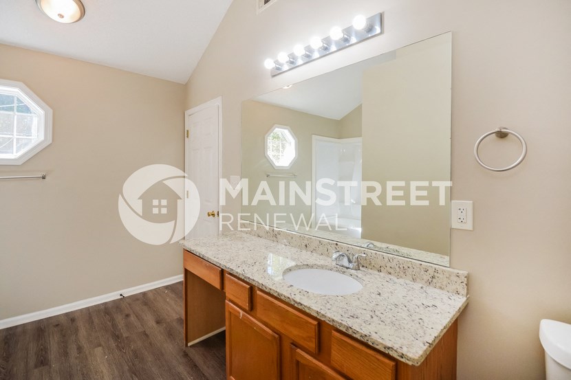 a bathroom with a sink and a mirror and a toilet