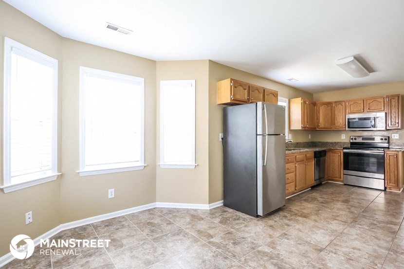 a kitchen with stainless steel appliances and wooden cabinets