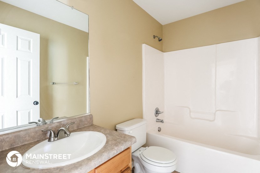 a bathroom with a sink and a toilet and a mirror