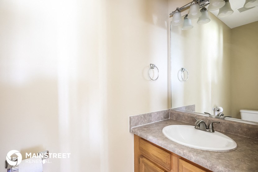 a bathroom with a sink and a shower and a mirror