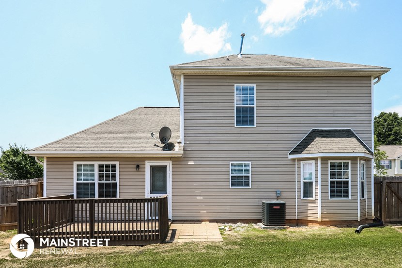 a home with a deck and a wooden fence