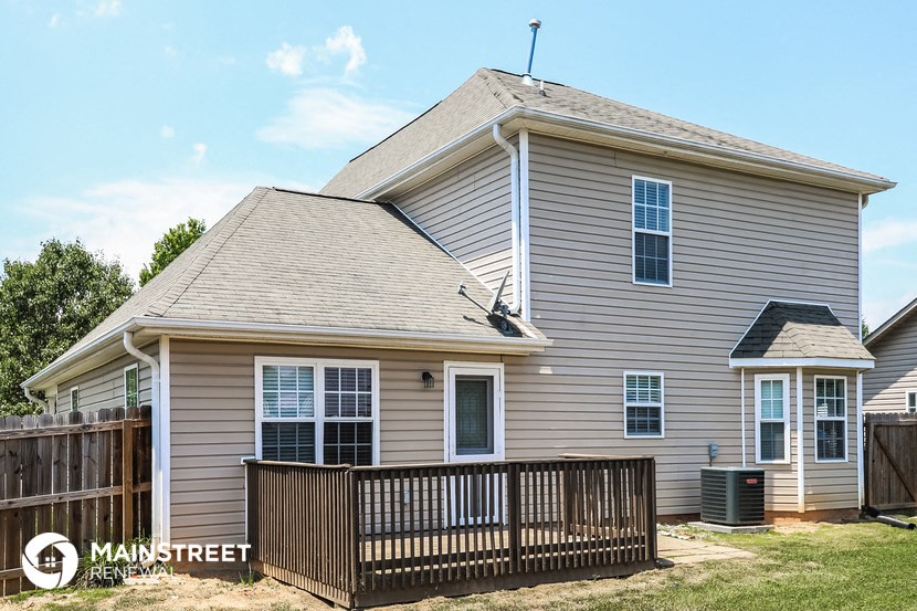 a house with a wooden fence in front of it