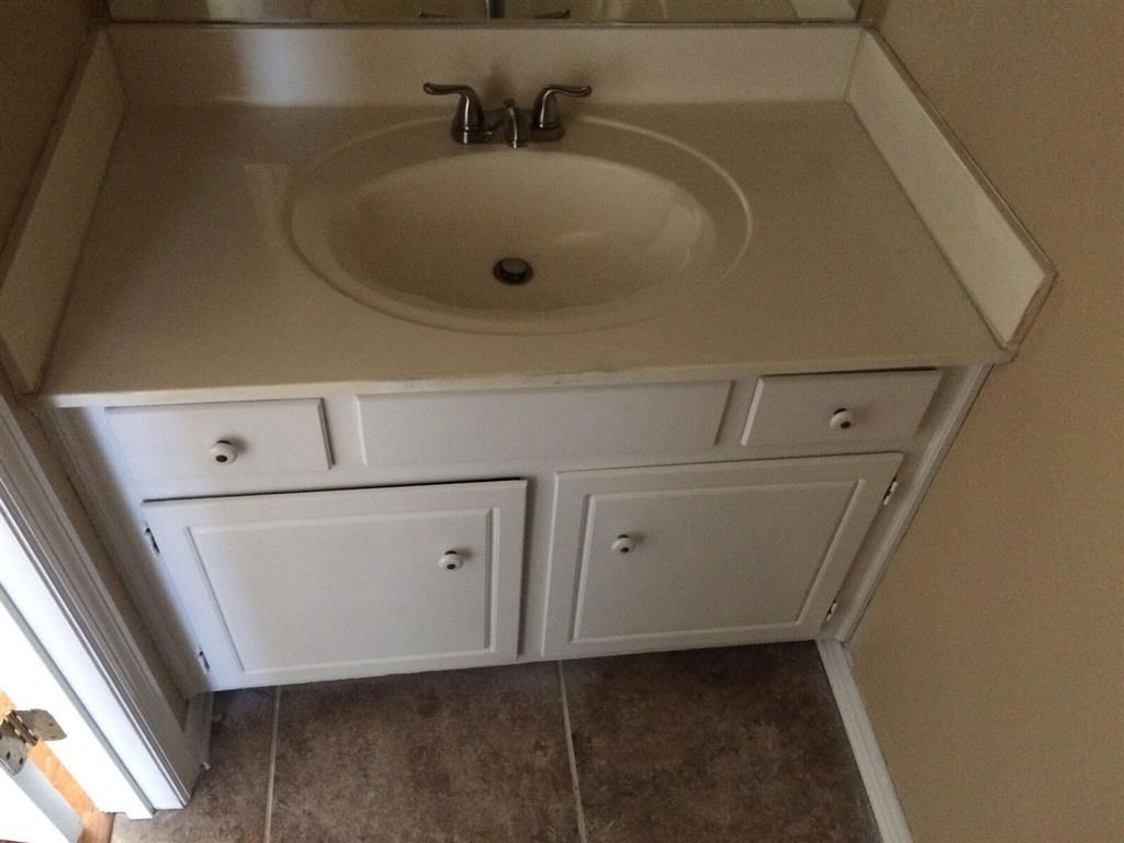 a bathroom with a sink and some cabinets