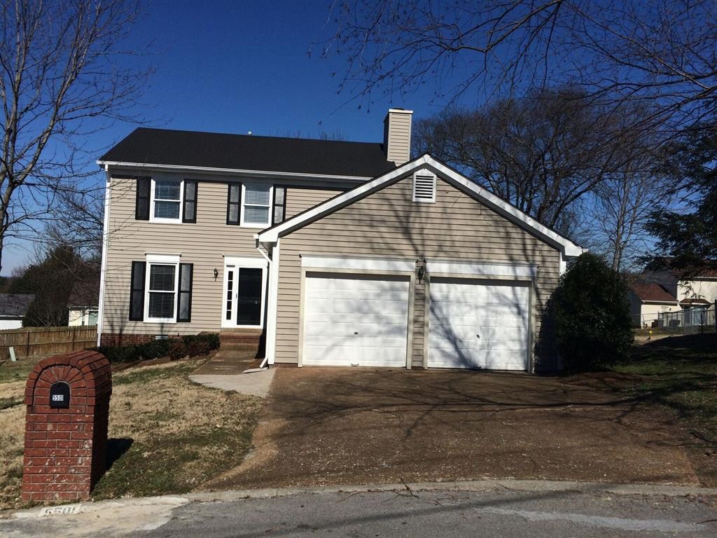 a house with a white garage door in front of it