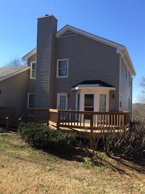 a house with a wooden deck in front of it