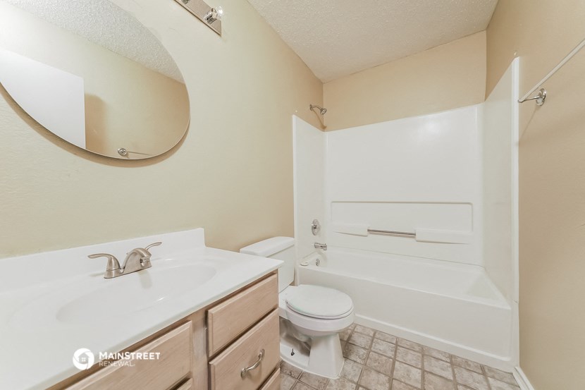 a bathroom with a sink toilet and a bath tub