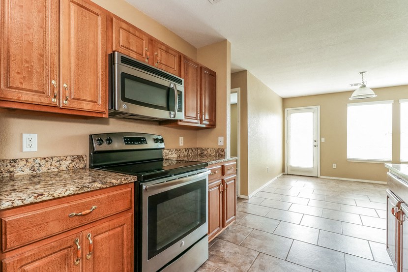 a kitchen with stainless steel appliances and wooden cabinets
